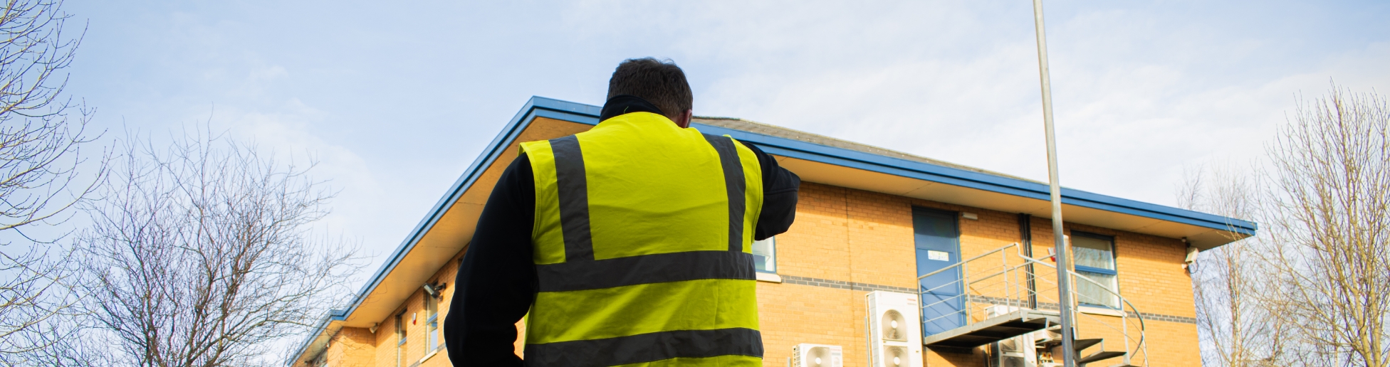 a man in a hi vis outside a building